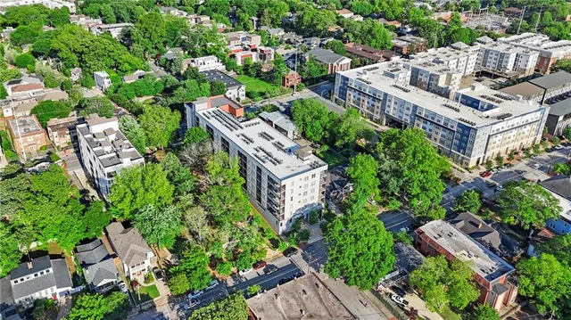 an aerial view of multiple houses with yard