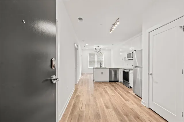 a bathroom with a sink mirror and shower
