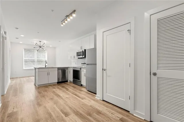 a kitchen with stainless steel appliances a refrigerator and a sink