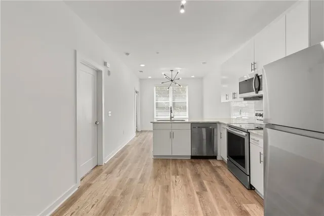 a kitchen with a refrigerator sink and stove top oven