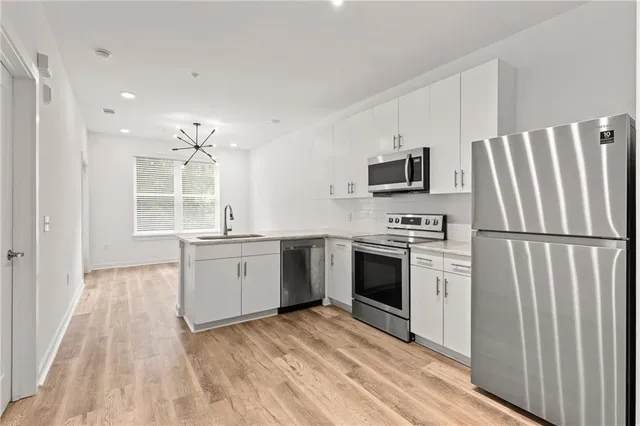 a kitchen with a refrigerator stove and sink
