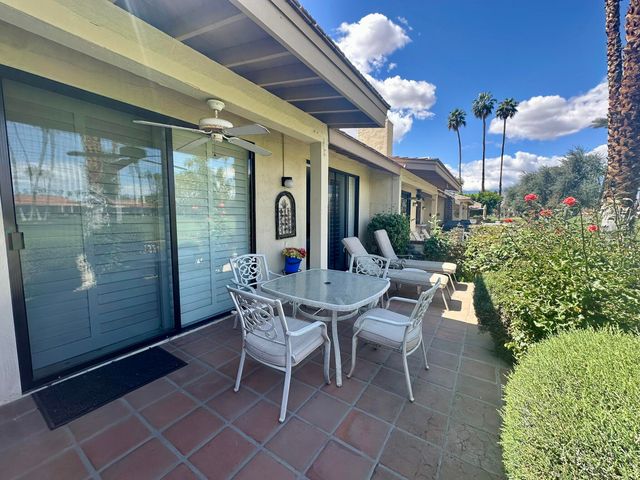 a patio with table and chairs