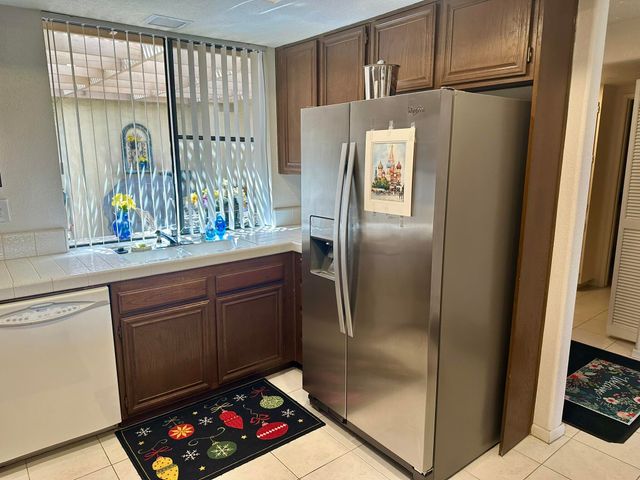 a spacious bedroom with a bed and a chandelier