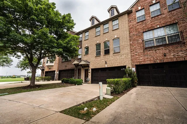 a front view of a building with a garden