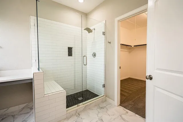 a bathroom with a shower and a sink