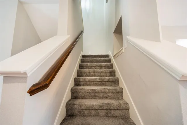 a view of a hallway with furniture and stairs