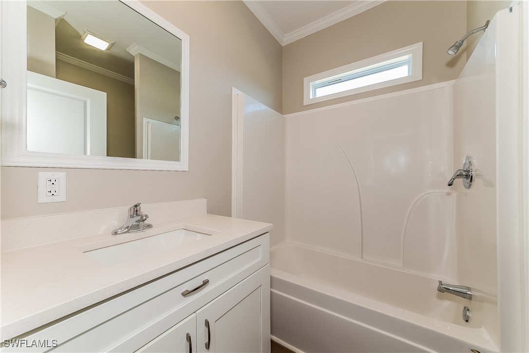 217 Santurce Avenue North Port, FL 34287 - Photo 15 of 16 a bathroom with a sink a mirror and a bathtub