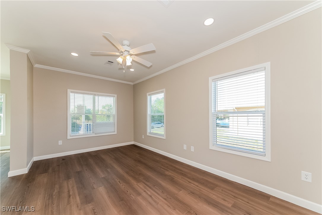 217 Santurce Avenue North Port, FL 34287 - Photo 4 of 16 a view of an empty room with wooden floor and a window