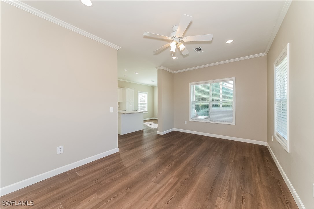 217 Santurce Avenue North Port, FL 34287 - Photo 5 of 16 an empty room with wooden floor fan and windows
