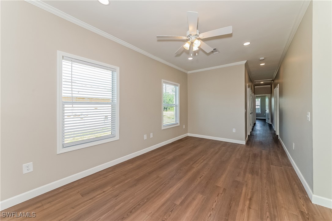 217 Santurce Avenue North Port, FL 34287 - Photo 6 of 16 a view of an empty room with wooden floor and a window