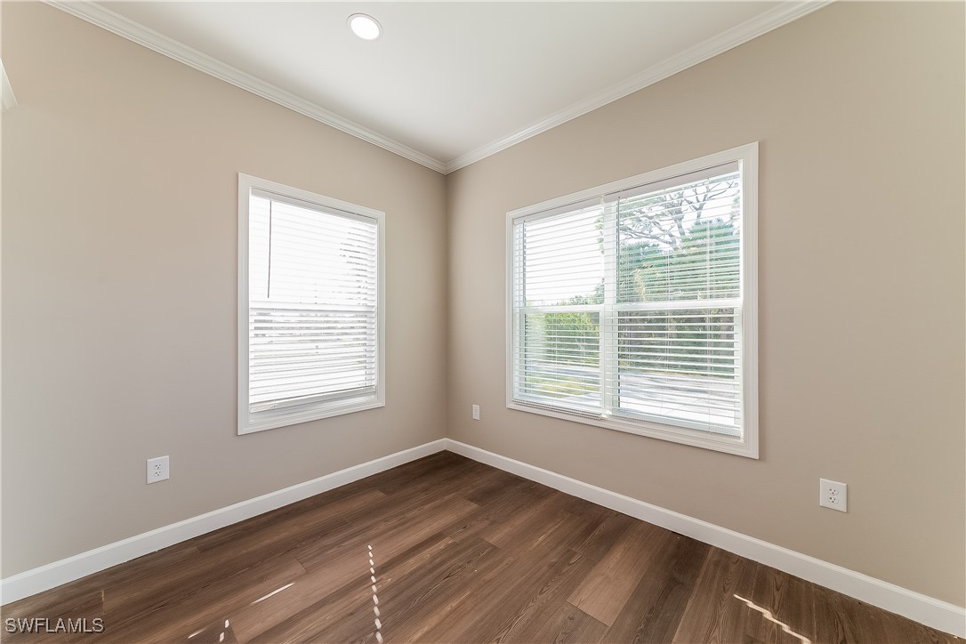217 Santurce Avenue North Port, FL 34287 - Photo 7 of 16 a view of an empty room with wooden floor and a window