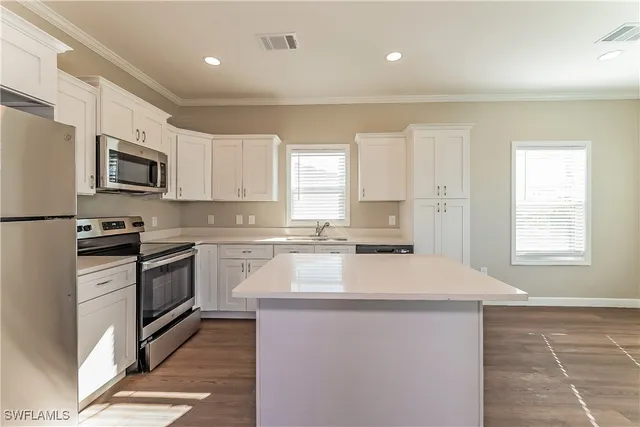 a kitchen with stainless steel appliances a microwave sink stove and refrigerator