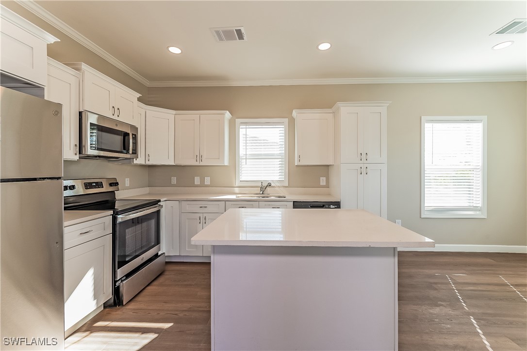217 Santurce Avenue North Port, FL 34287 - Photo 9 of 16 a kitchen with stainless steel appliances a microwave sink stove and refrigerator