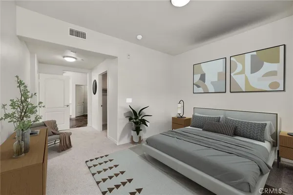 a bedroom with a large bed and a couch