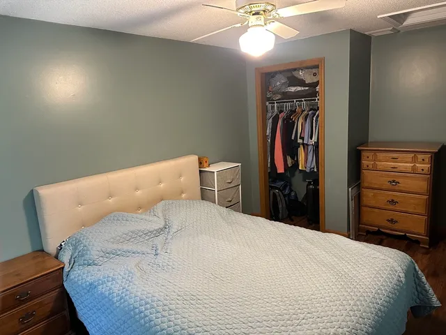 a bed sitting in a bedroom and dresser
