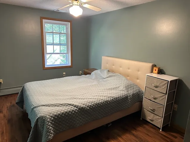 a bed sitting in a bedroom next to a window