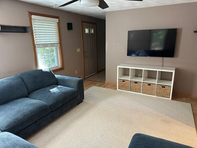 a living room with a flat screen tv and a window