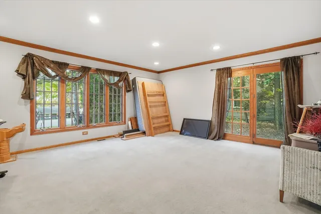 a view of an empty room with a fireplace and a large window
