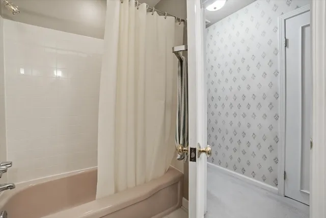 a bathroom with a bathtub and a shower