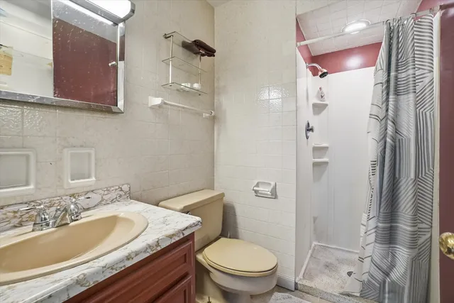 a bathroom with a sink toilet and shower