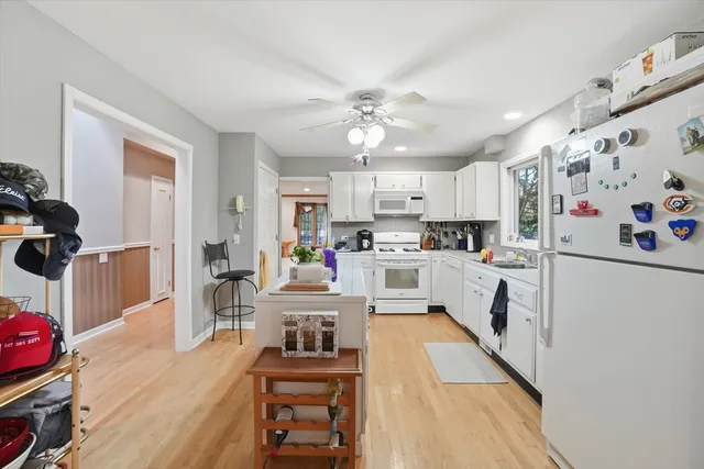 a kitchen with cabinets and wooden floor