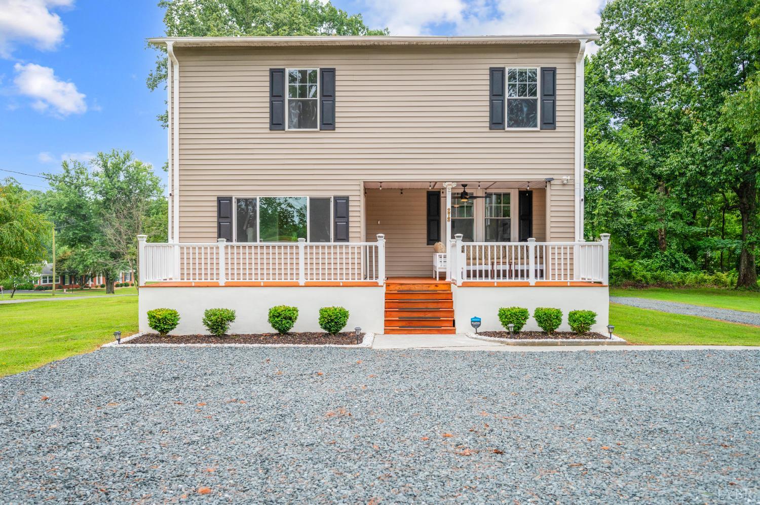 a front view of a house with a yard and a garage