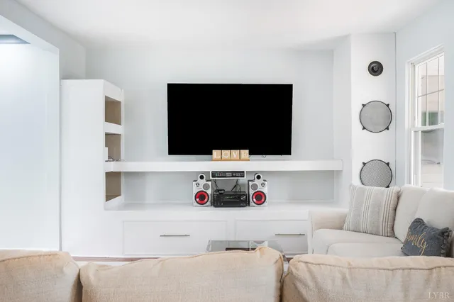 a stove sitting inside of a kitchen with white cabinets