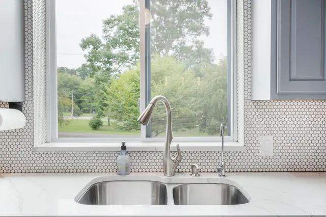 a view of a room with wooden floor and a refrigerator