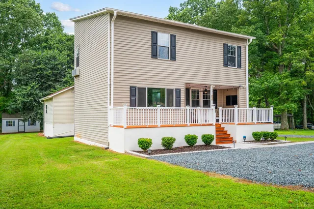 a view of house with yard and green space