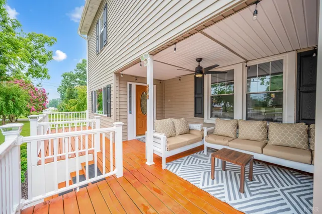 a view of a house with a yard and sitting area