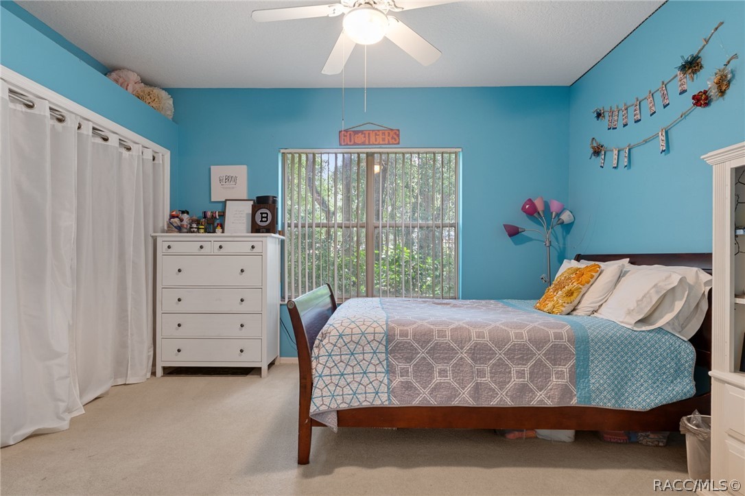 2460 West Pine Ridge Boulevard Beverly Hills, FL 34465 - Photo 28 of 47 a bedroom with a bed and a window