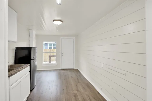 a view of a livingroom with wooden floor and a window