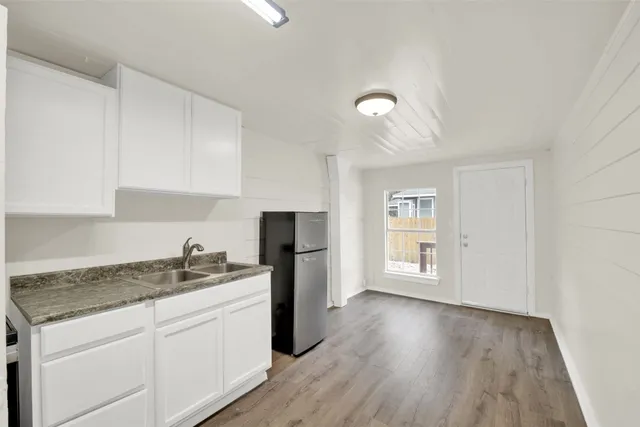 a kitchen with a refrigerator and cabinets