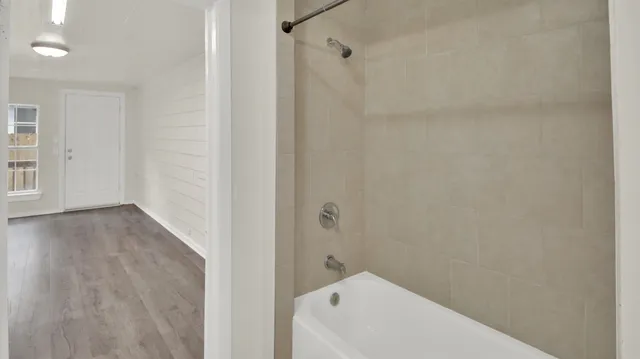 a bathroom with a bathtub and shower