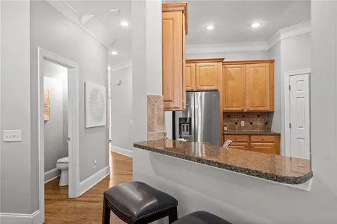 a kitchen with stainless steel appliances granite countertop a refrigerator and cabinets