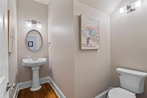 a bathroom with a toilet a sink and a mirror