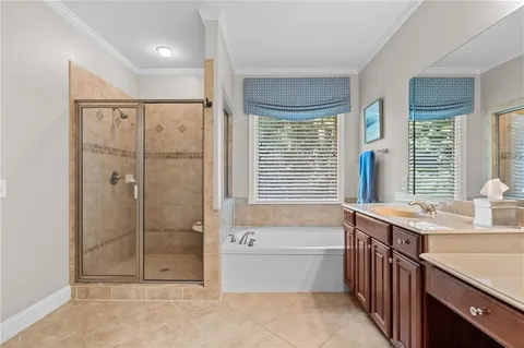a bathroom with a tub sink and shower