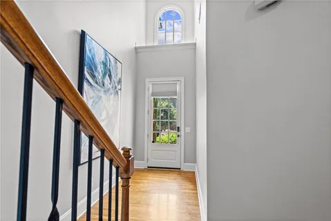 a view of an entryway with wooden floor