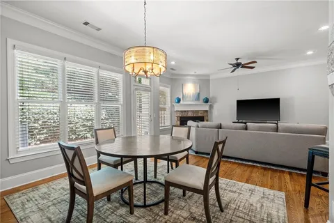 a view of a dining room with furniture wooden floor and chandelier