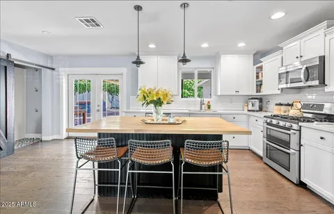 a large kitchen with a table and chairs in it