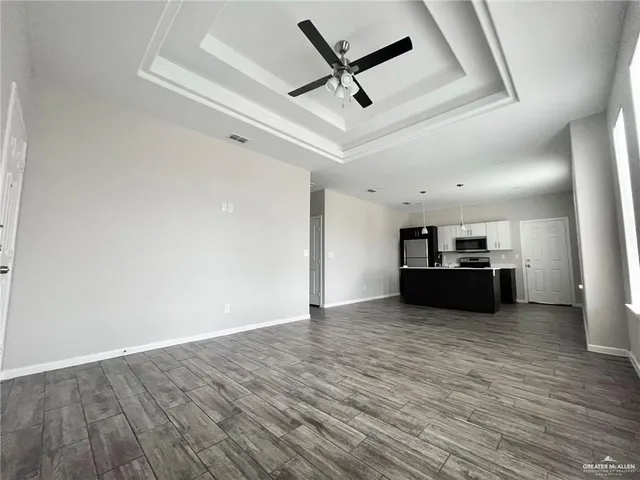 a view of a kitchen with a sink and a ceiling fan