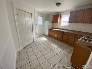 210 Coleman Street, Unit 1 Bridgeport, CT 06604 - Photo 6 of 8 a kitchen with stainless steel appliances granite countertop a sink and cabinets