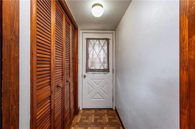 a view of kitchen with stainless steel appliances granite countertop cabinets and window