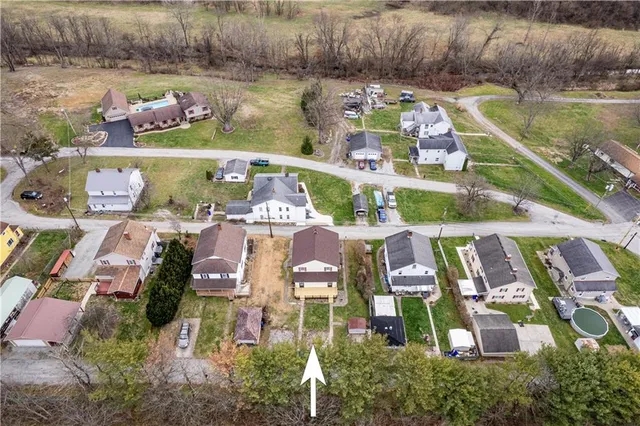 an aerial view of a house with a lake view