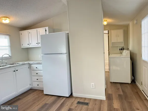 a white refrigerator freezer sitting inside of a kitchen