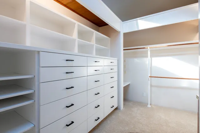a bathroom with a double vanity sink a large mirror and shower