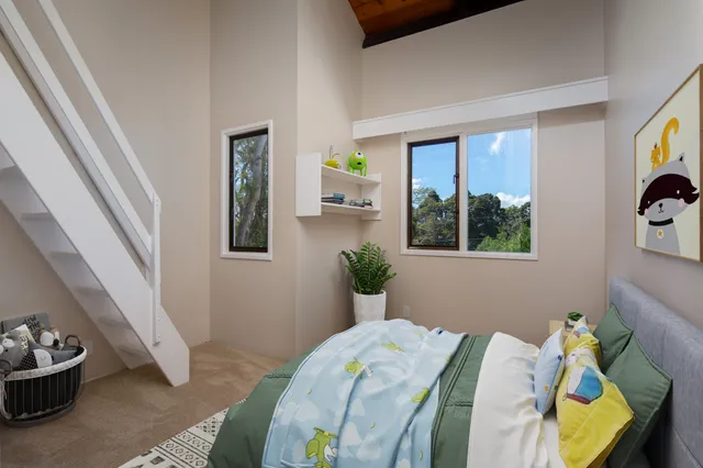 a view of hallway with stairs and a window