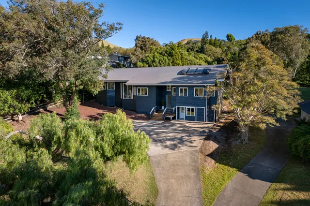 an aerial view of a house with a yard basket ball court and outdoor seating