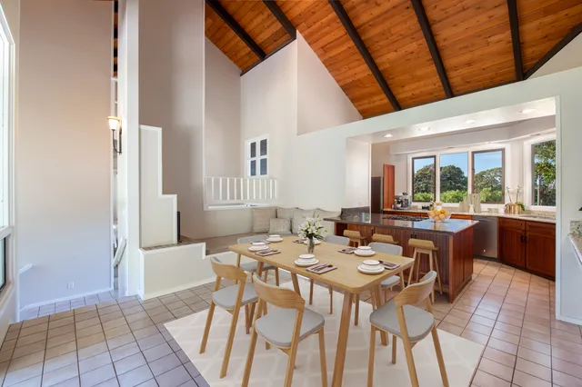 a large white kitchen with granite countertop a sink and a stove top oven