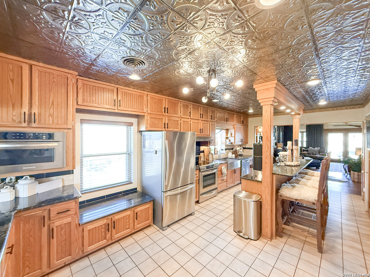 2828 2nd Street Pleasanton, TX 78064 - Photo 12 of 48 a kitchen with stainless steel appliances kitchen island granite countertop a refrigerator and cabinets